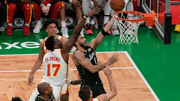 Boston Celtics forward Jayson Tatum shoots over Atlanta Hawks forward Onyeka Okongwu.